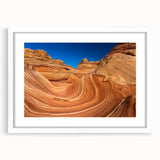 Abstract art print of Coyote Buttes in Arizona, featuring earthy red and orange tones on a white-framed mat.