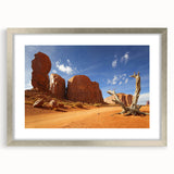 Textured art of Monument Valley in muted earth tones on a framed silver mat, ideal for bedroom decor.