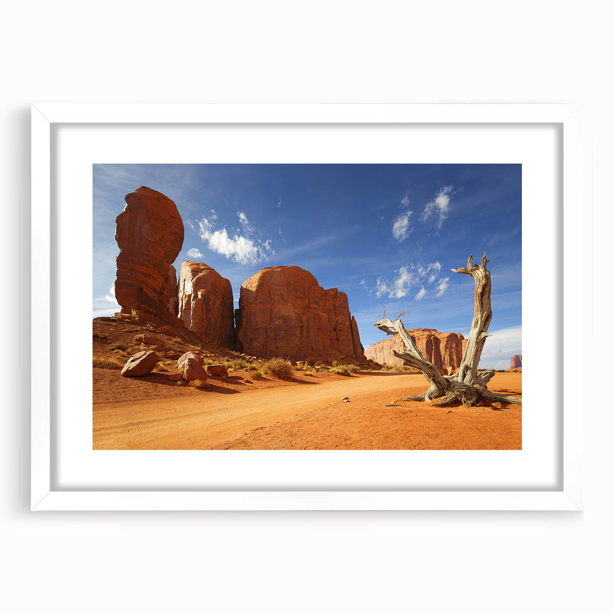 Abstract art print of Monument Valley in muted earth tones on a framed white mat, ideal for dining room decor.