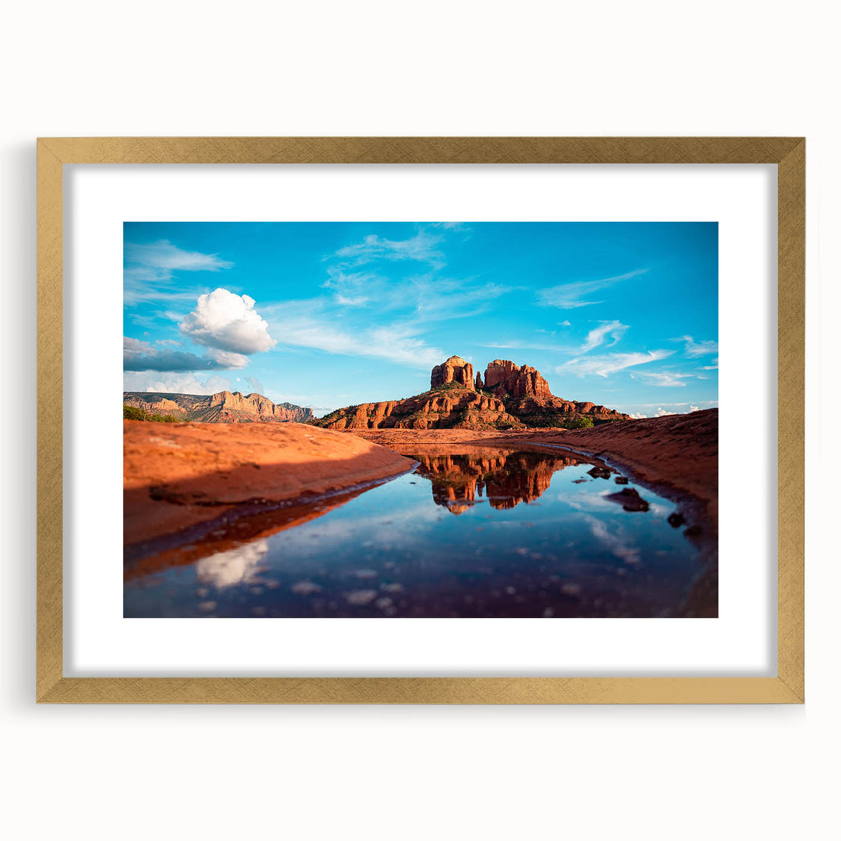 Extra large abstract art print of Sedona landscape in muted earth tones on a textured canvas, framed in gold.