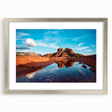 Textured art print of Sedona's red rock landscape in muted earth tones, framed in silver, ideal for bedroom ambiance.