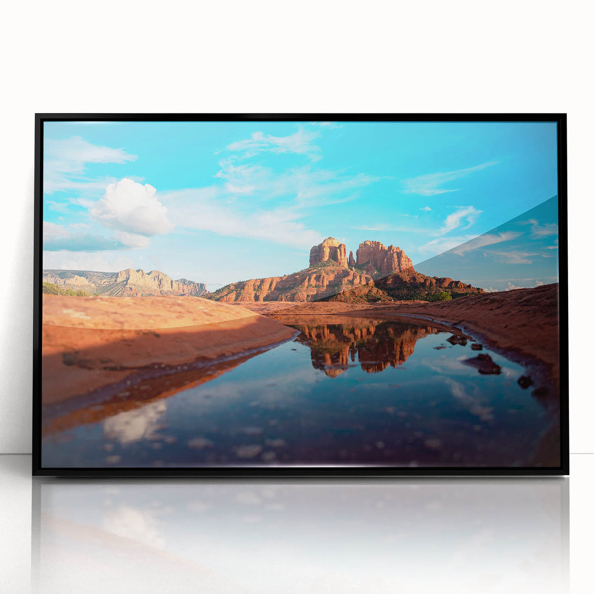Large abstract wall art depicting the Sedona landscape in vibrant red and orange tones, framed in black acrylic.