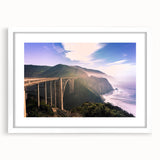 Abstract art print of Big Sur in muted blue and green tones, framed with a white mat, ideal for dining room decor.