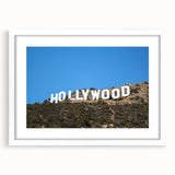 Abstract art print depicting the Hollywood skyline in muted gray and blue tones, framed with a white mat.