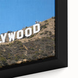 Close-up of textured black wall art depicting the Hollywood, California skyline on a framed canvas.