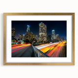 Extra large abstract art print of Los Angeles skyline in vibrant gold and blue tones on a framed canvas.