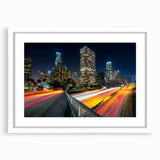 Abstract art print of Los Angeles skyline in muted gray and blue tones on a framed white canvas.