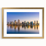 Extra large abstract art print of San Diego skyline in muted blue tones, framed in gold, suitable for living room decor.