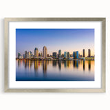 Textured abstract art print depicting the San Diego skyline in muted blue and gray, framed in silver.