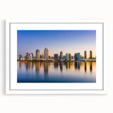 Abstract art print of San Diego skyline in muted blue and gray tones, framed in white, ideal for dining room decor.