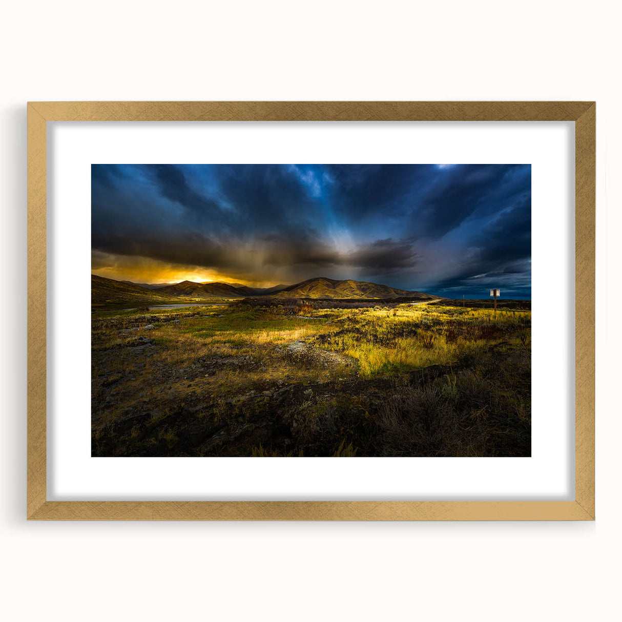 Extra large abstract art print featuring textured scenery of Idaho in muted earth tones, framed in gold.
