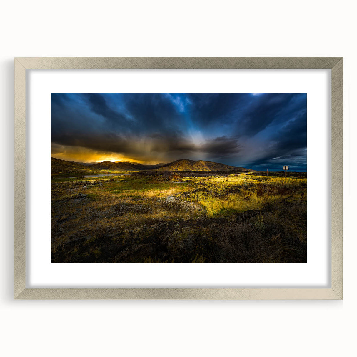 Textured art depicting an abstract Idaho landscape in muted earth tones on a framed silver mat, ideal for bedroom decor.