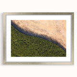 Textured abstract art print depicting rolling hills in Iowa, in earthy green and brown tones, framed in silver.