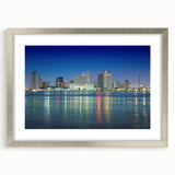 Textured abstract art print of New Orleans scenery in muted earth tones, framed in silver, suitable for bedroom decor.
