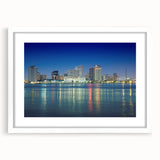 Abstract art print of New Orleans skyline in muted gray and blue tones on a framed white mat, ideal for dining room decor.