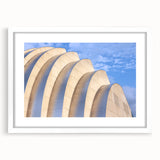 Abstract art print of Kansas City skyline in muted blue and gray tones on a white framed canvas.