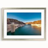 Textured abstract art print of Hoover Dam in muted gray tones on a framed silver mat, ideal for modern bedroom decor.