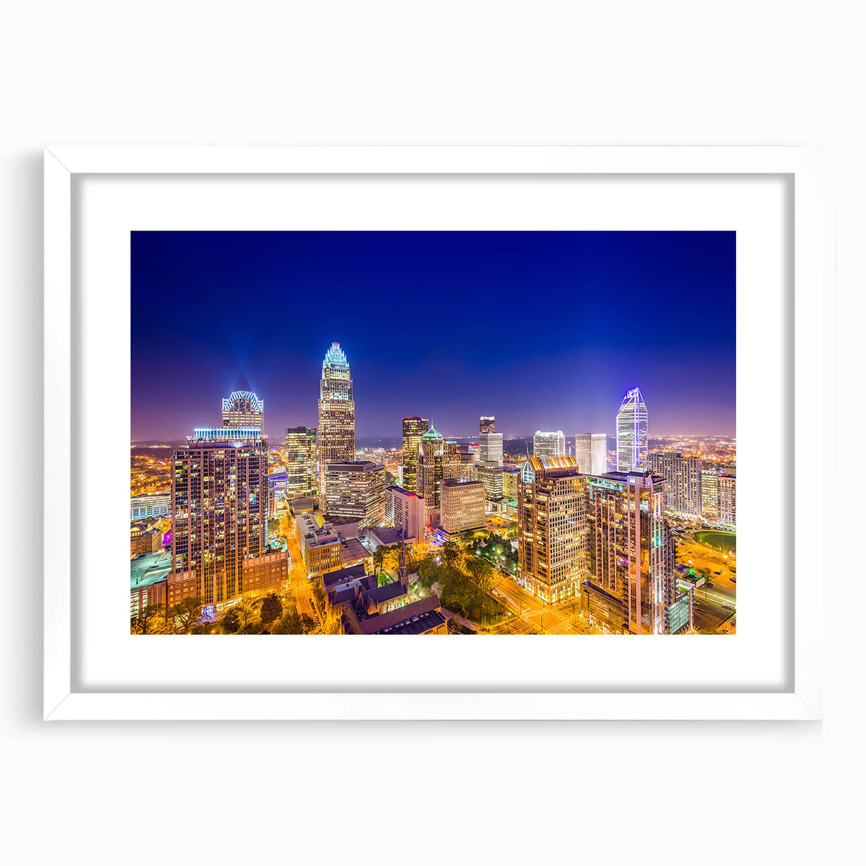Abstract art print of Charlotte skyline in muted blue and gray tones on a white framed canvas.