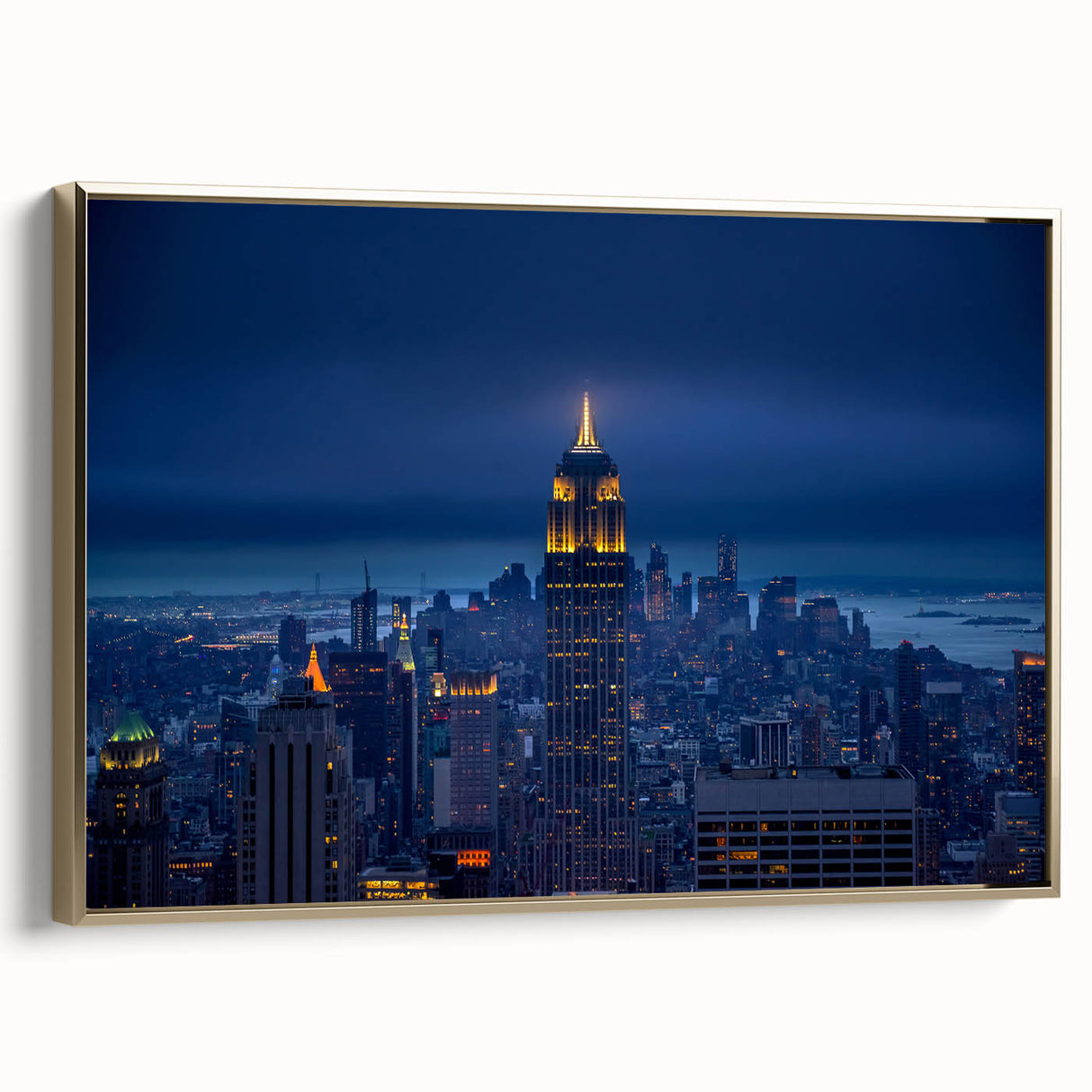 Framed canvas wall art depicting the Empire State Building in black and gold tones, suitable for bedroom decor.