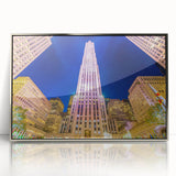 Mid-century modernist art of NYC Rockefeller Center in silver-framed acrylic, featuring muted urban colors.