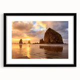 Colorful art print of Cannon Beach, Oregon, in vibrant blues and oranges on a large textured canvas.