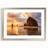 Textured art print of Cannon Beach, Oregon with abstract design in muted gray and blue tones on a silver-framed mat.