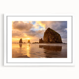 Abstract art print of Cannon Beach in muted gray and blue tones on a white framed poster, suitable for dining room decor.