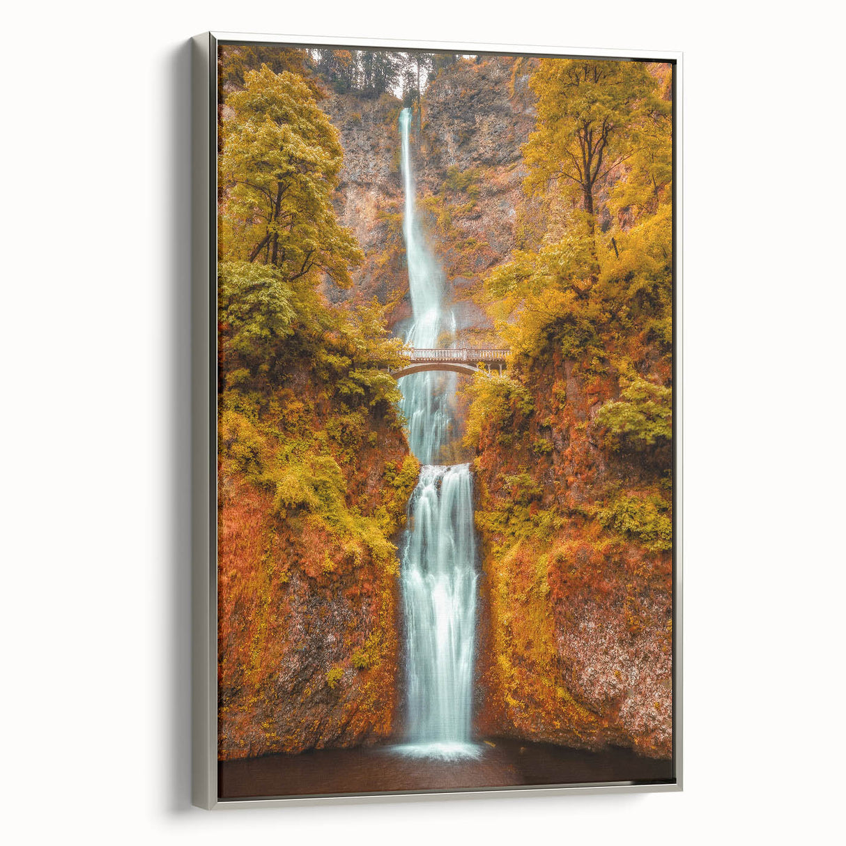 Framed canvas depicting Multnomah Falls in Oregon with lush greenery in muted colors.