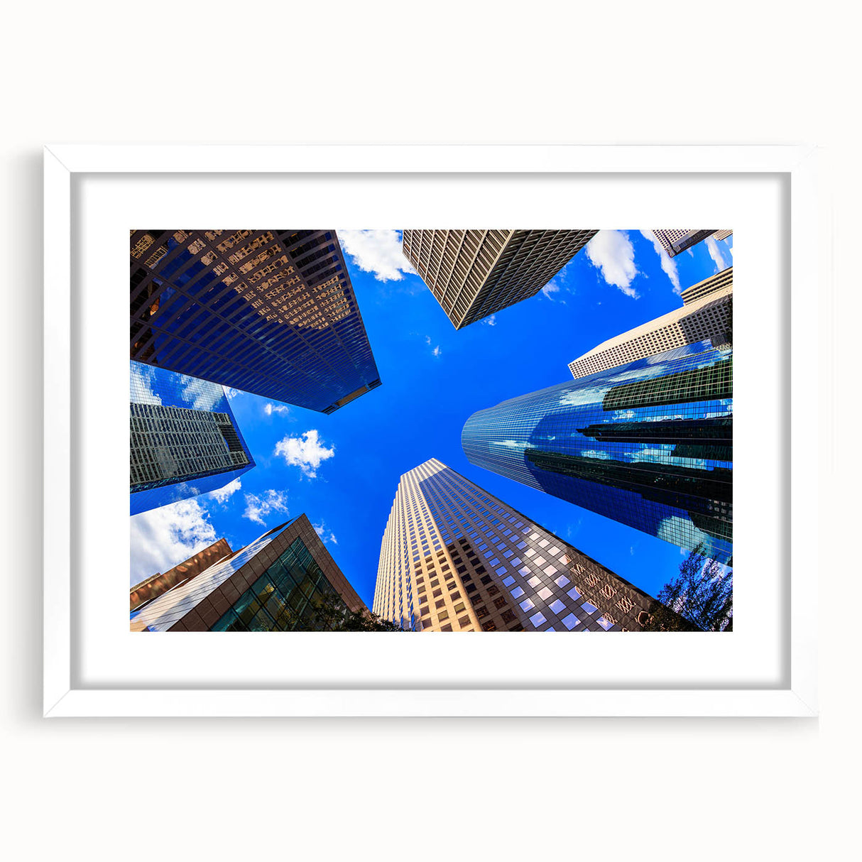 Abstract art print of Houston skyline in muted gray and blue tones, framed with a white mat, suitable for dining room decor.