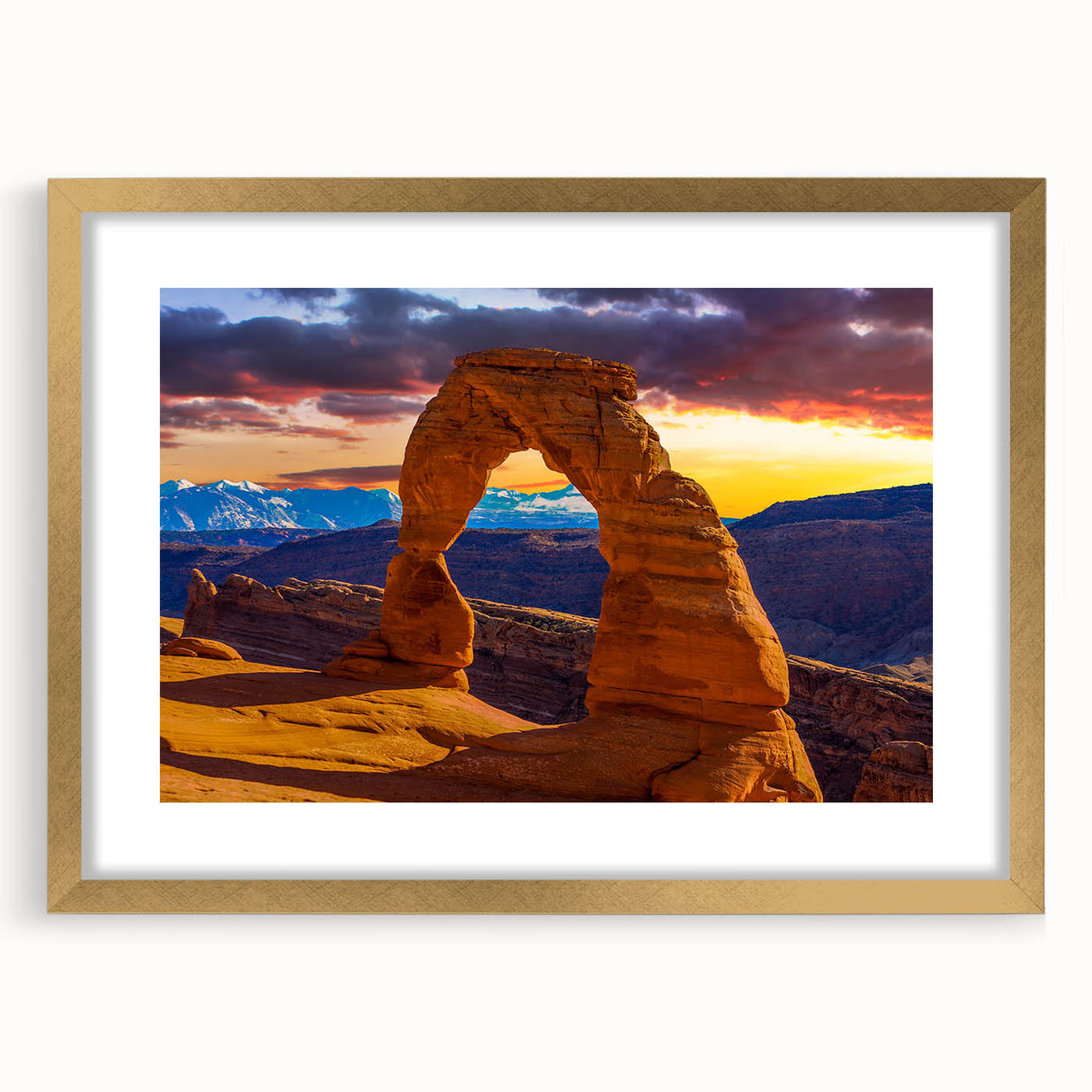 Extra large wall art depicting abstract Arches National Park in textured hues of orange and red, framed in gold.