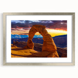 Textured art depicting abstract formations in earthy tones on a framed silver mat, suitable for bedroom decor.