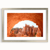Textured art depicting abstract Bryce Canyon in muted orange and brown hues on a framed silver mat.