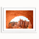 Abstract art print of Bryce Canyon in muted orange and red tones, framed with a white mat, ideal for dining room decor.