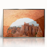 Mid-century modernist art depicting Bryce Canyon in muted orange and red tones on a silver-framed acrylic print.