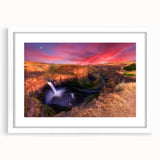 Abstract art print depicting the rolling hills of the Palouse in muted green and brown tones, framed in white.