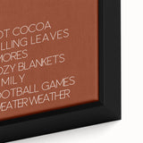 Close-up of a black framed canvas featuring a textured, colorful abstract design with autumnal hues.