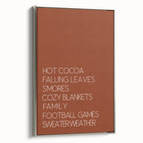 Framed canvas featuring a vintage poster-style landscape art painting of autumn trees in vibrant orange and red tones.