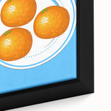 Close-up of black wall art featuring colorful, textured fruits on a large framed canvas, ideal for living room decor.