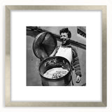 Textured abstract art print featuring indistinct figures in neutral tones, framed in silver, suitable for bedroom decor.