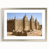 Abstract art print of a Mali scenery in muted earth tones on a framed canvas, suitable for dining room decor.