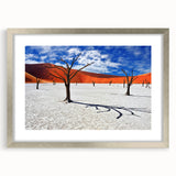 Abstract art print of African scenery in muted earth tones on a framed silver mat, suitable for dining room or bedroom decor.