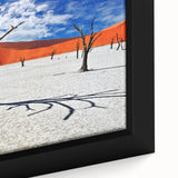 Framed canvas of a textured African landscape in black with colorful accents, ideal for large living room walls.