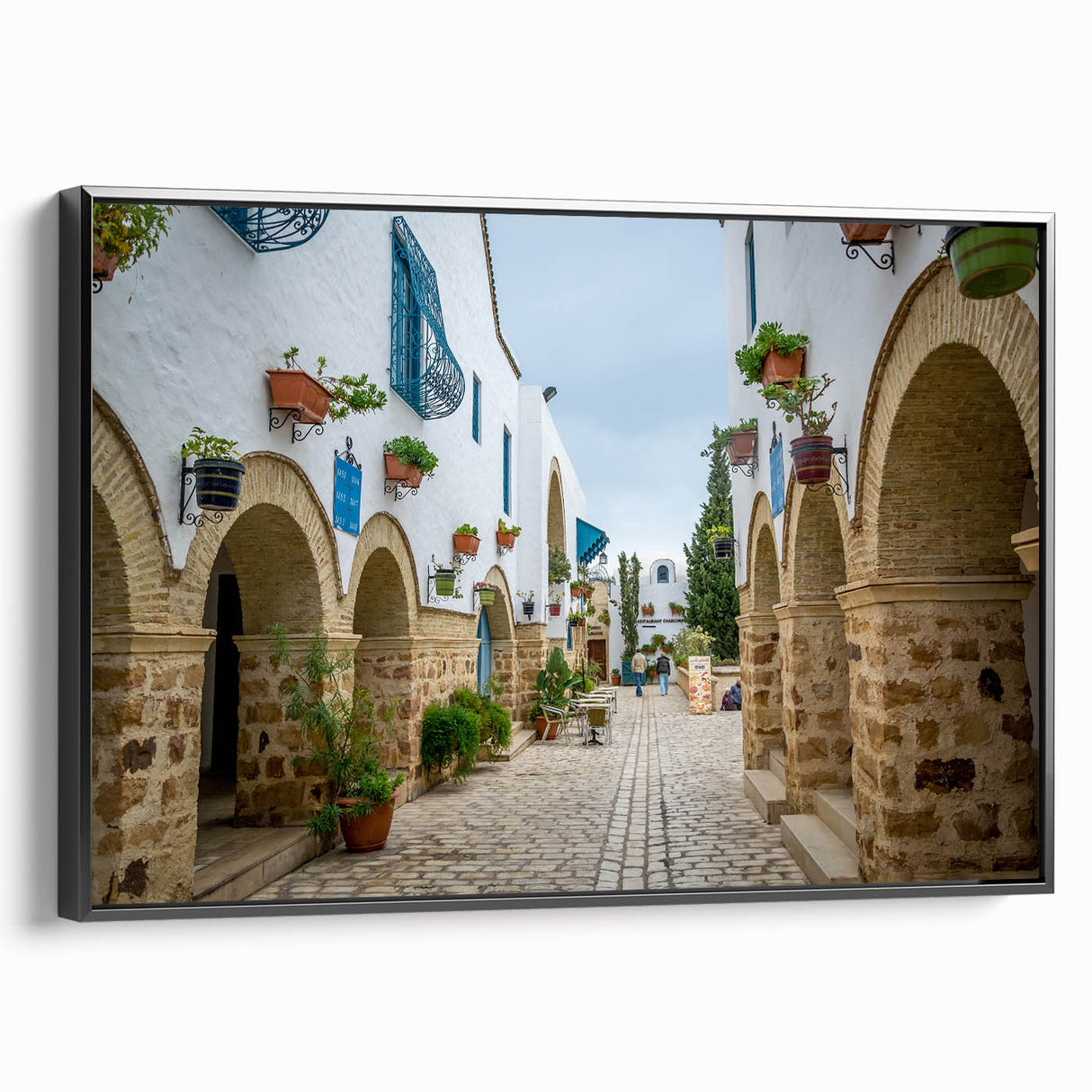 Black and white framed canvas of a Tunisian landscape, ideal for bedroom wall decor.