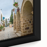 Textured black wall art depicting a Tunisian landscape on a framed canvas, featuring vibrant, colorful details.