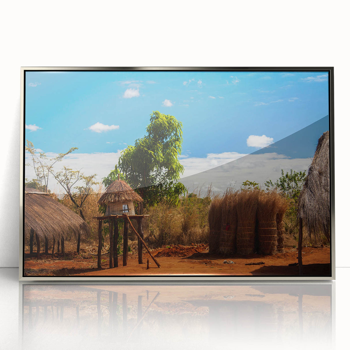 Mid-century modernist art depicting Zambia scenery in muted earth tones on a silver-framed acrylic print.