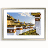 Textured abstract art print of Bhutan scenery in muted earth tones, framed in silver, suitable for bedroom art.