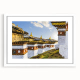 Abstract art print of Bhutanese landscape in muted earth tones on a white-framed mat, ideal for dining room decor.