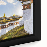 Extra large framed canvas featuring a textured depiction of Bhutan scenery in black with colorful art accents.