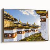 Framed canvas wall art featuring a serene Bhutanese landscape in muted gold and black tones, suitable for bedroom decor.