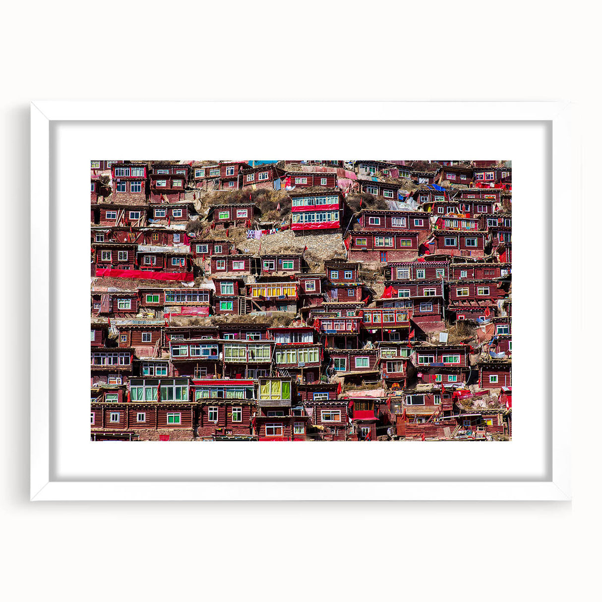 Abstract art print of a Tibetan landscape in muted blue and green tones on a white framed canvas.